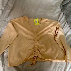 Very cute long sleeve top, beige in color , New w/ tags, Size Large